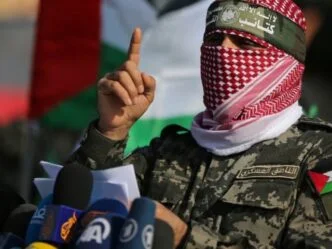 abu ubaida the spokesman of the izz el deen al qassam brigades gestures as he speaks during an anti israel military show in the southern gaza strip november 11 2019 photo reuters