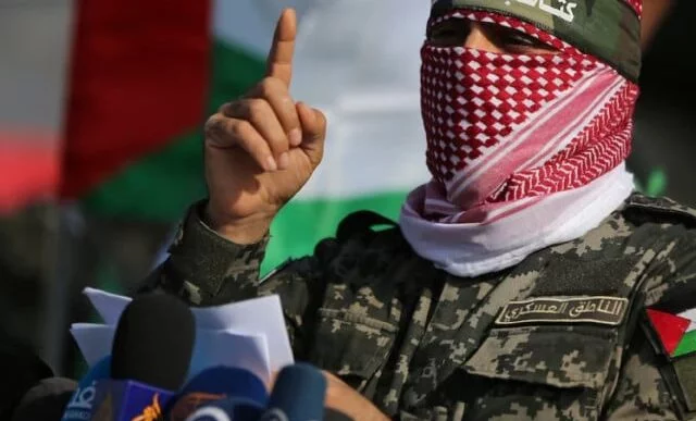 abu ubaida the spokesman of the izz el deen al qassam brigades gestures as he speaks during an anti israel military show in the southern gaza strip november 11 2019 photo reuters