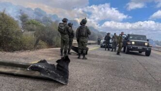 israeli soldiers stand on a damaged road near the israel lebanon border after hezbollah fired a of projectiles towards israel from lebanon amid cross border hostilities between hezbollah and israeli forces in northern israel sept 4 2024 photo reuters