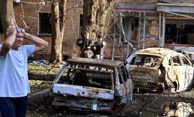 a man reacts while standing next to burnt out remains of cars in the courtyard of a multi storey residential building which according to local authorities was hit by debris from a destroyed ukrainian missile in the course of russia ukraine conflict in kursk russia photo reuters