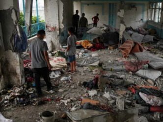 palestinians check the damage at the un run school that was hit by an israeli air attack in nuseirat photo afp