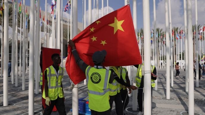 Workers get ready to hoist the national flag of China at the venue of the UNFCCC COP28 Climate Conference on November 29, 2023, the day before its official opening in Dubai, United Arab Emirates. COP28 is bringing together stakeholders, including international heads of state and other leaders, scientists, environmentalists, activists and others to discuss and agree on the implementation of global measures toward mitigating the effects of climate change. (See story on Page 4) Photo: VCG