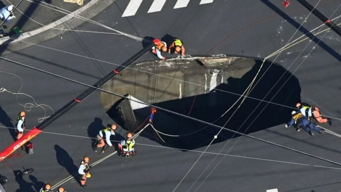 Swimming pool-sized sinkhole swallows truck in Japan, trapping driver inside