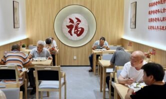 Senior citizens have meals at a canteen for elderly people at a community in Jin