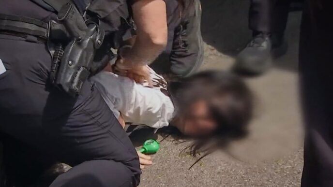 Massachusetts police hold girl's face to the ground as ICE arrests her mother, video shows