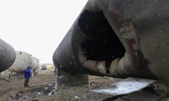 A worker inspects the damage at the AES Group private oil refinery the day after a Russian shock drone attack, in Merefa, Kharkiv region, Ukraine, on March 18, 2025. It marks the fourth attack on the enterprise since February 2022, the AES Group officials said. Photo: VCG