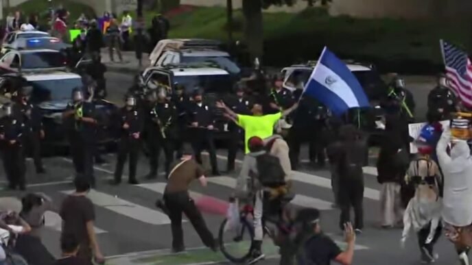 Reporter falls back with dispersed L.A. protesters amid flash-bangs, tear gas
